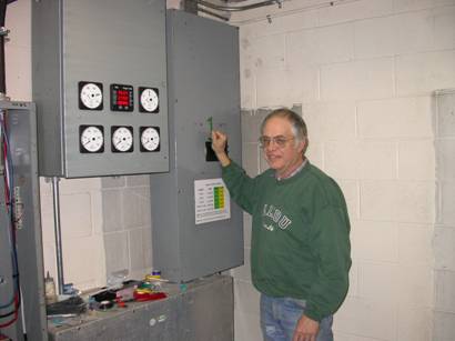 Brian Anderson at the main switch to put camp on hydro power!