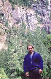 John Kautz, long time friend of Malibu with waterfall behind.